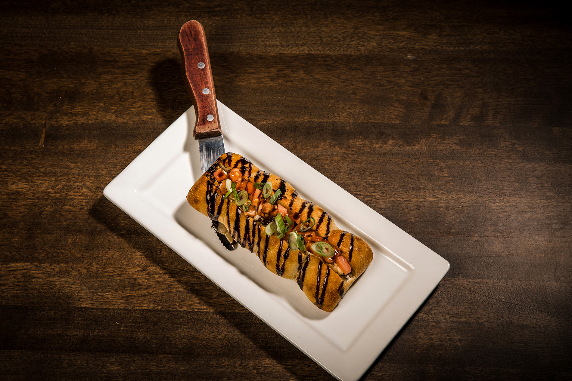 Ciabatta Goat Cheese Loaf at Wendel Clark's Classic Grill & Bar: a stuffed ciabatta loaf with tomato, green onion and balsamic glaze